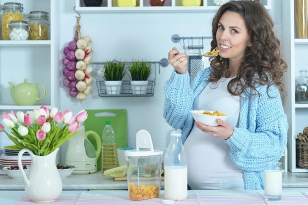 Pregnant woman enjoying healthy food, applying sunscreen, and staying hydrated